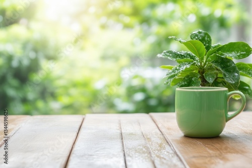 A vibrant green mug sits on a wooden table, bathed in natural light, with a small plant in the foreground, amidst a blurred background of lush greenery