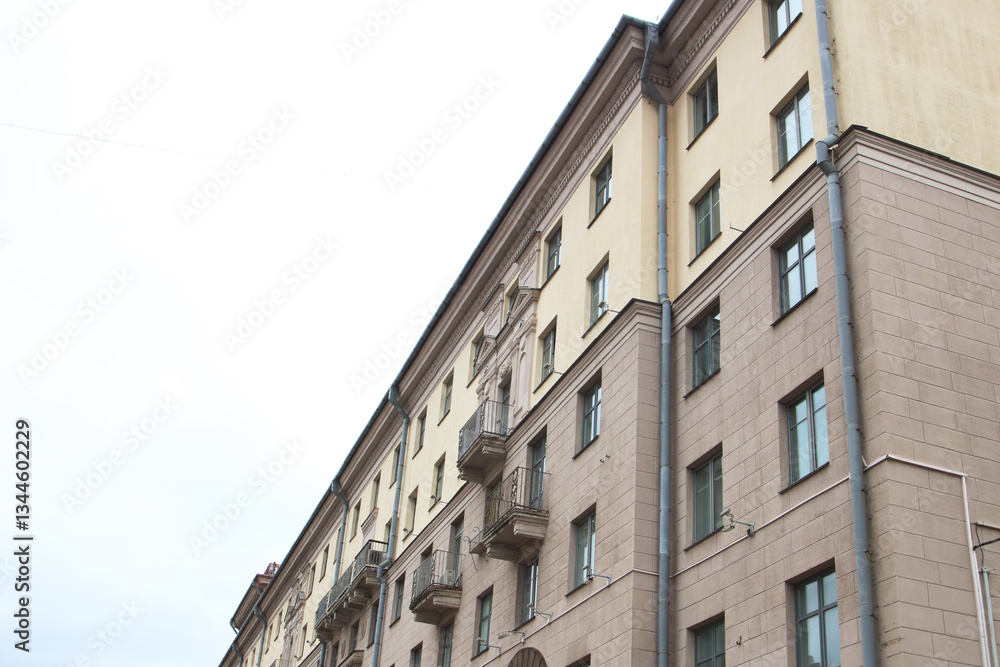 I gaze at a tall building adorned with balconies and windows I gaze at a tall building adorned with balconies and windows