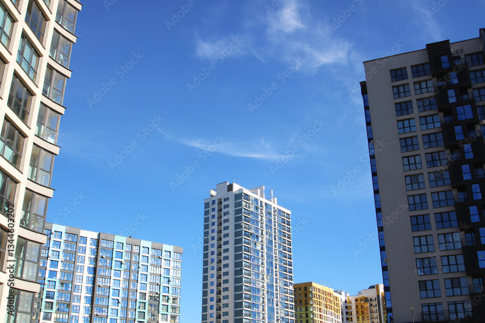 Tall buildings under a bright blue sky create a stunning landscape Tall buildings under a bright blue sky create a stunning landscape