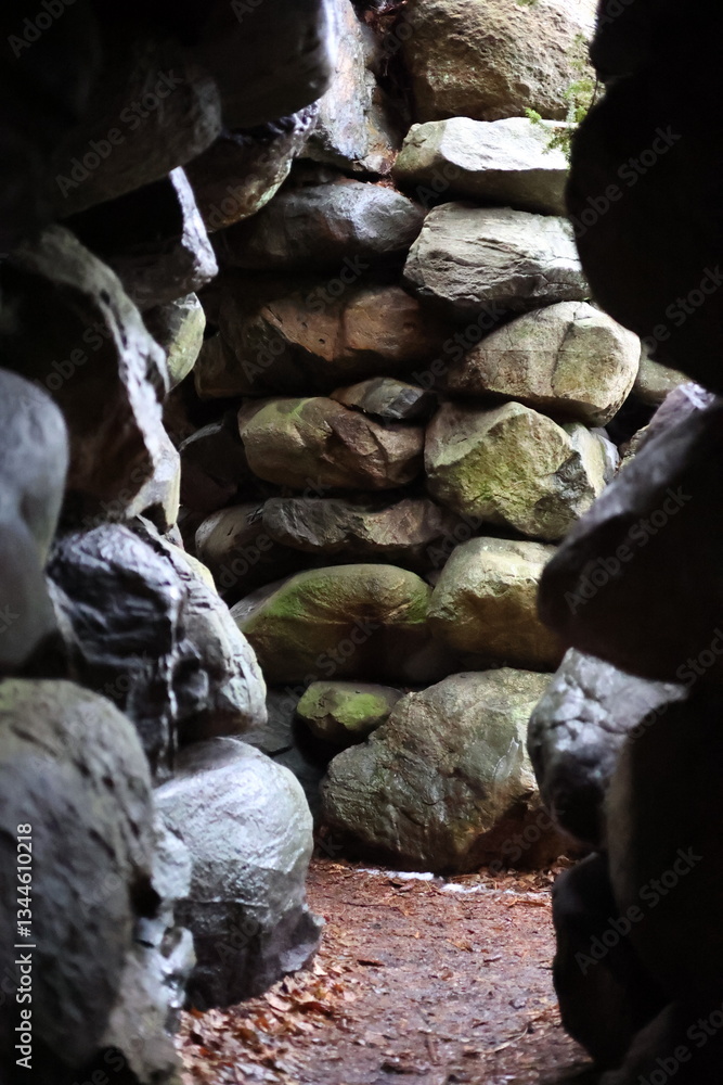 Ancient Stone Passageway with Mossy Rocks in a Natural Cave