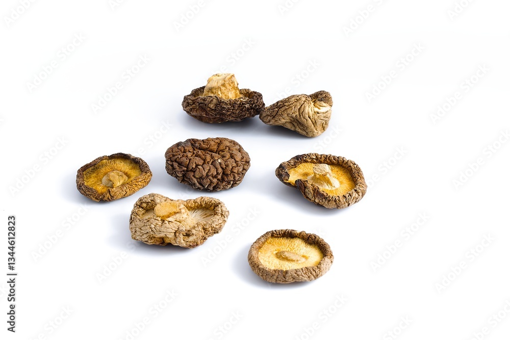 A crisp image of dried shiitake mushrooms on white, highlighting their rustic texture and earthy, natural tones.