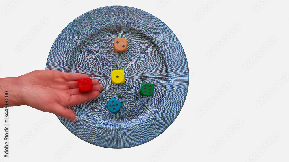 Hand adding a red dice to a blue plate with colorful dice, representing gambling and luck