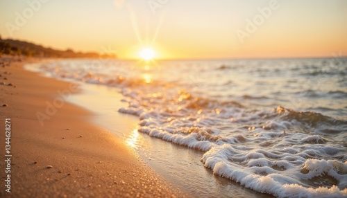 Beach at sunset with gentle waves hitting the shore