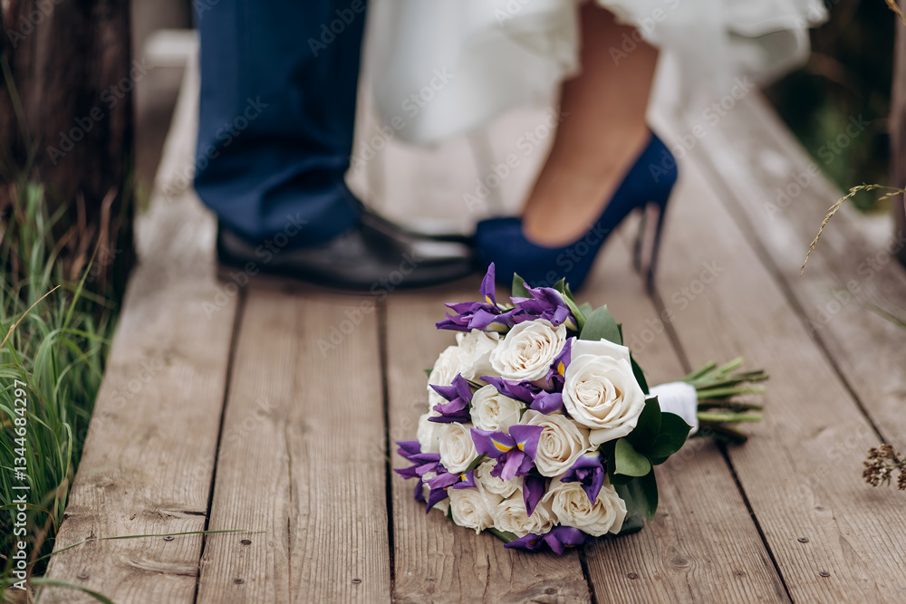 feet of the bride and groom next to the wedding bouquet feet of the bride and groom next to the wedding bouquet