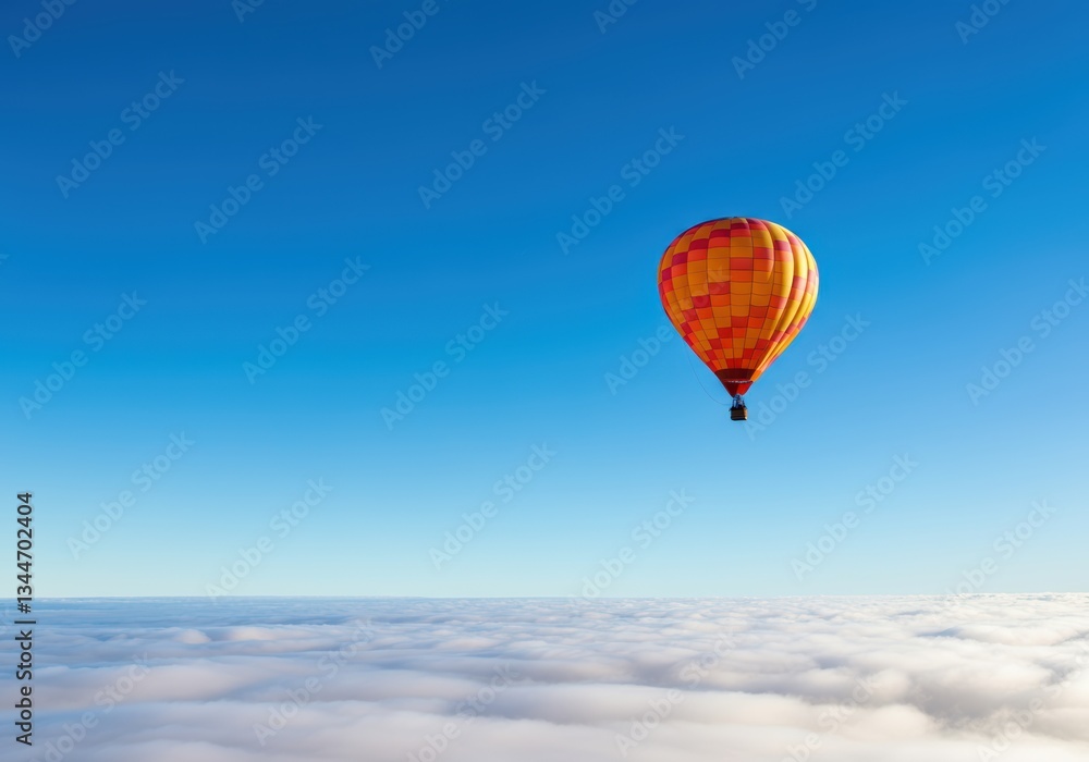 Obraz premium Colorful hot air balloon soaring above the clouds in a clear blue sky