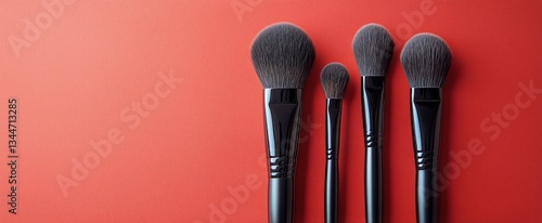 Makeup Brushes Arranged Neatly on a Vibrant Red Background for Beauty Applica...