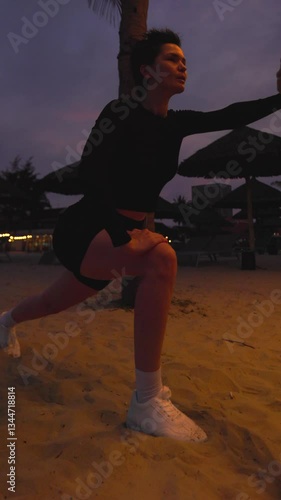 Sunset beach workout: dynamic stretching and athletic focus on sand