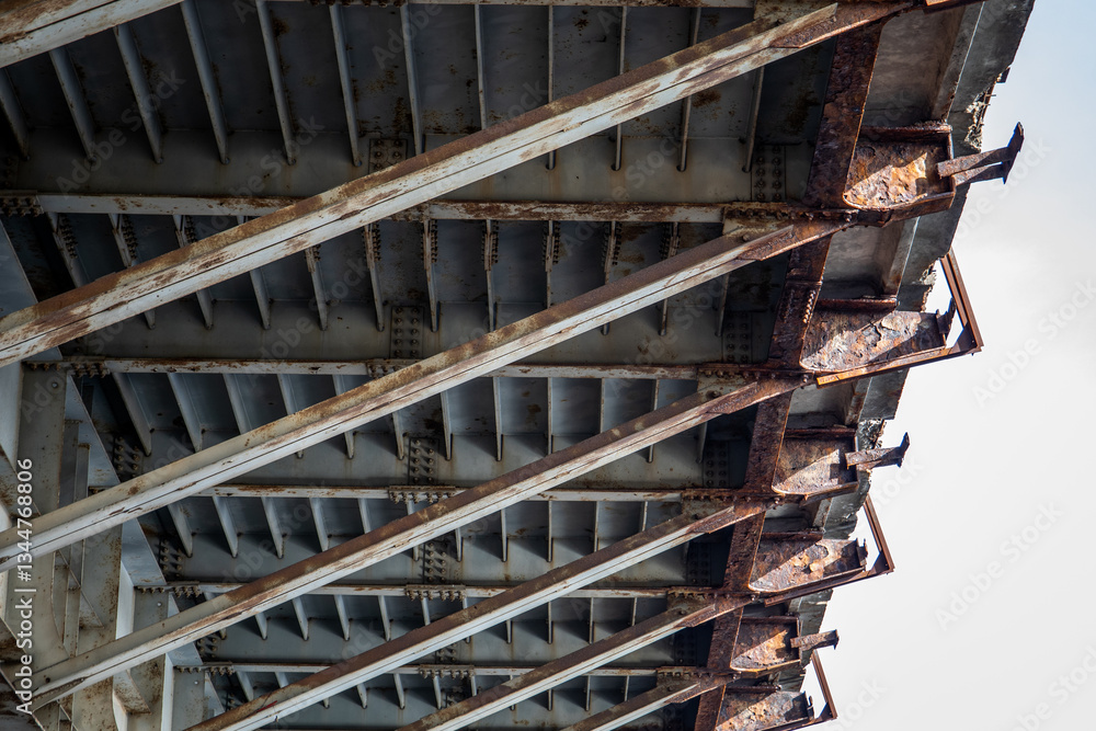 Rusty Bridge Understructure with Metal Beams and Weathered Steel Supports Rusty Bridge Understructure with Metal Beams and Weathered Steel Supports