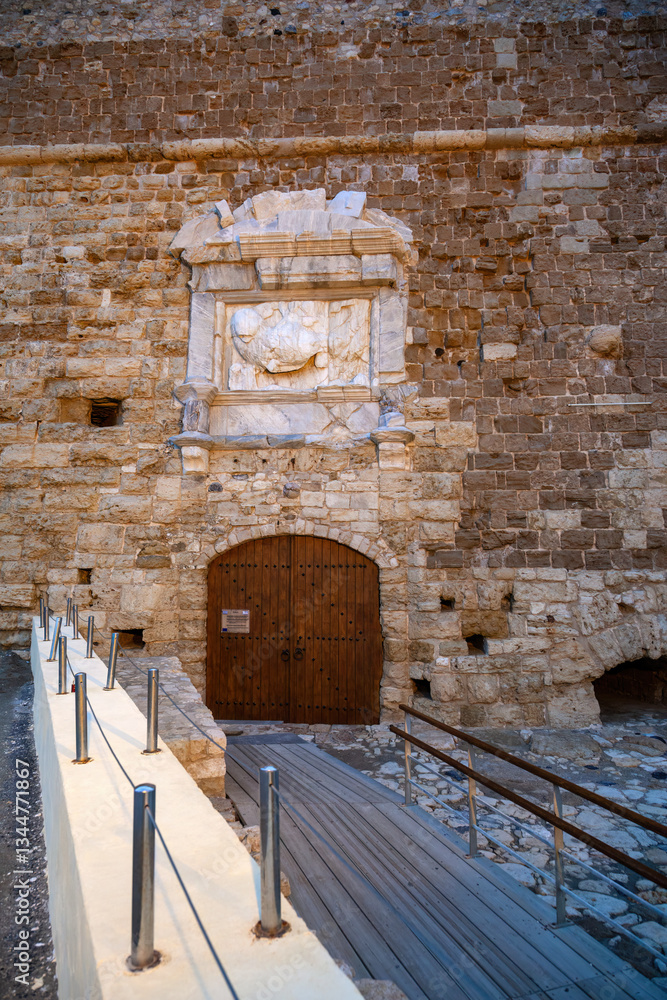 Venetian Koules Fortress in Heraklion, Crete, Greece. Historic stone walls, wooden gate, and marble relief of the Lion of Saint Mark. A famous Mediterranean landmark
