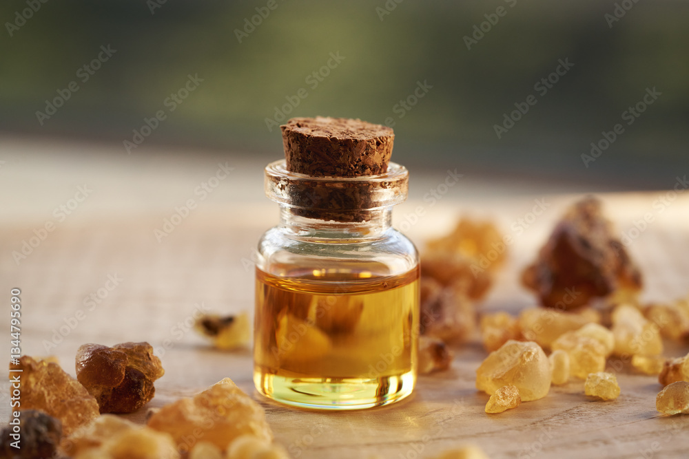 A bottle of frankincense essential oil with frankincense resin A bottle of frankincense essential oil with frankincense resin