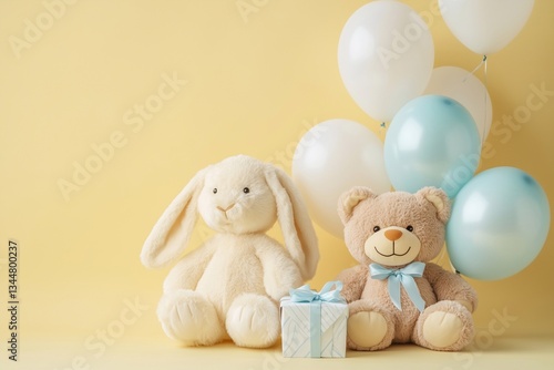 Soft plush toys bear and white bunny with gift box and balloons, yellow studio wall, copy space. Baby shower background