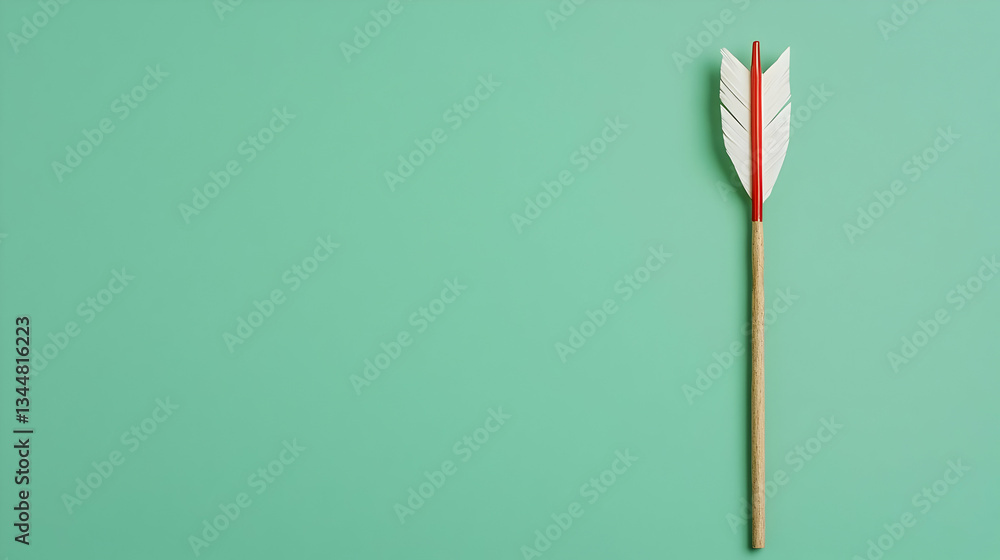 Simple Wooden Arrow With White And Red Feathers On Teal Background Simple Wooden Arrow With White And Red Feathers On Teal Background