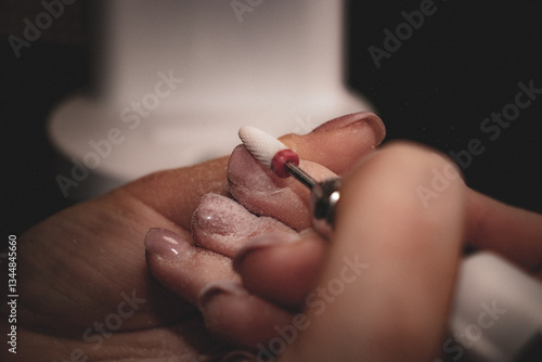 Nail Technician Using Electric Nail Drill for Manicure and Nail Care
