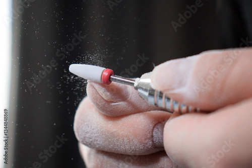 Nail Technician Using Electric Nail Drill for Manicure and Nail Care