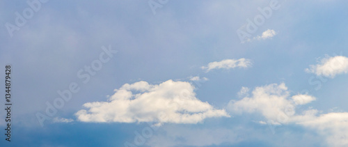 sky with small white clouds on a light blue background