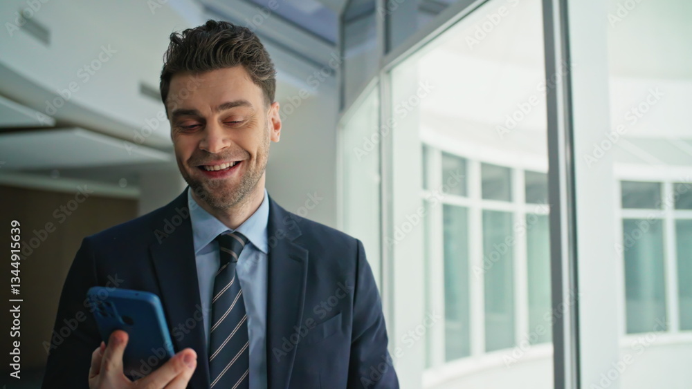 Smiling businessman answering cellphone call walking office corridor closeup. Smiling businessman answering cellphone call walking office corridor closeup.