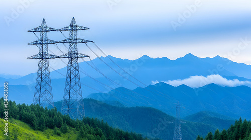 High-voltage towers stand tall against a misty mountain range