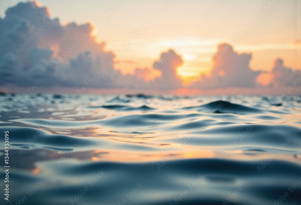 Obraz premium Serene ocean waves reflecting the warm glow of a sunset on the horizon