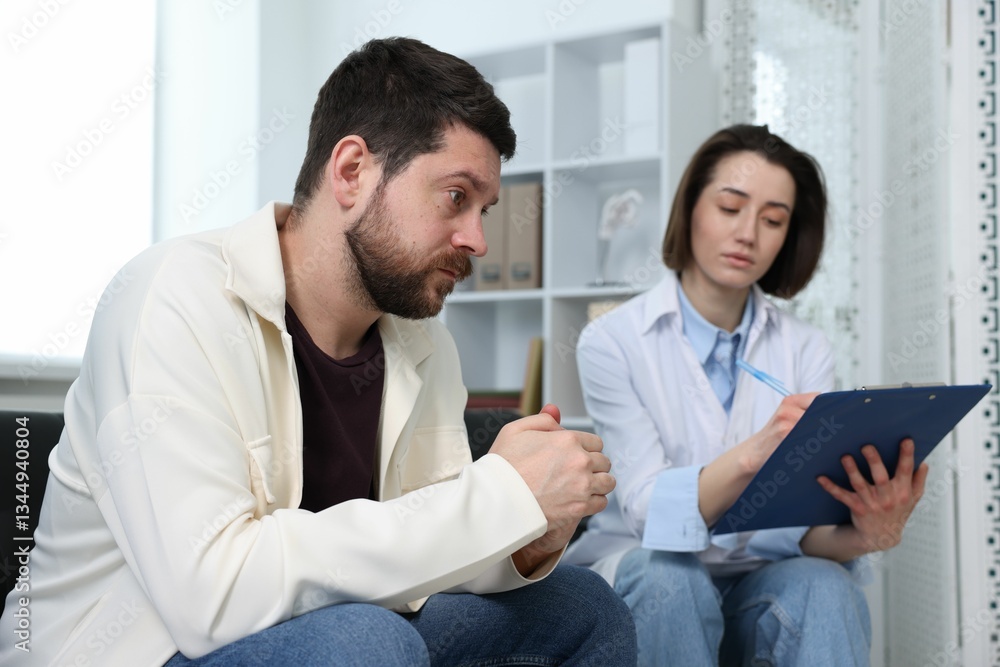 Alcoholic man having appointment with healthcare specialist in clinic. Addiction treatment Alcoholic man having appointment with healthcare specialist in clinic. Addiction treatment