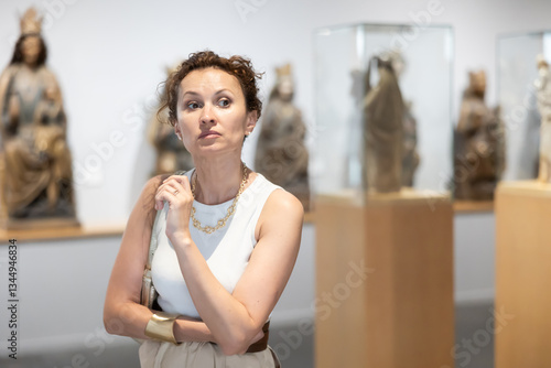 Free Download Woman visit museum, examines masterpiece at exhibition. Concept of intellectual recreation entertainment, exhibition of historical and artistic display item, showcases filled with historical artifacts - GFXLoad