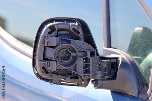 Close-up of a car's broken rear-view mirror.