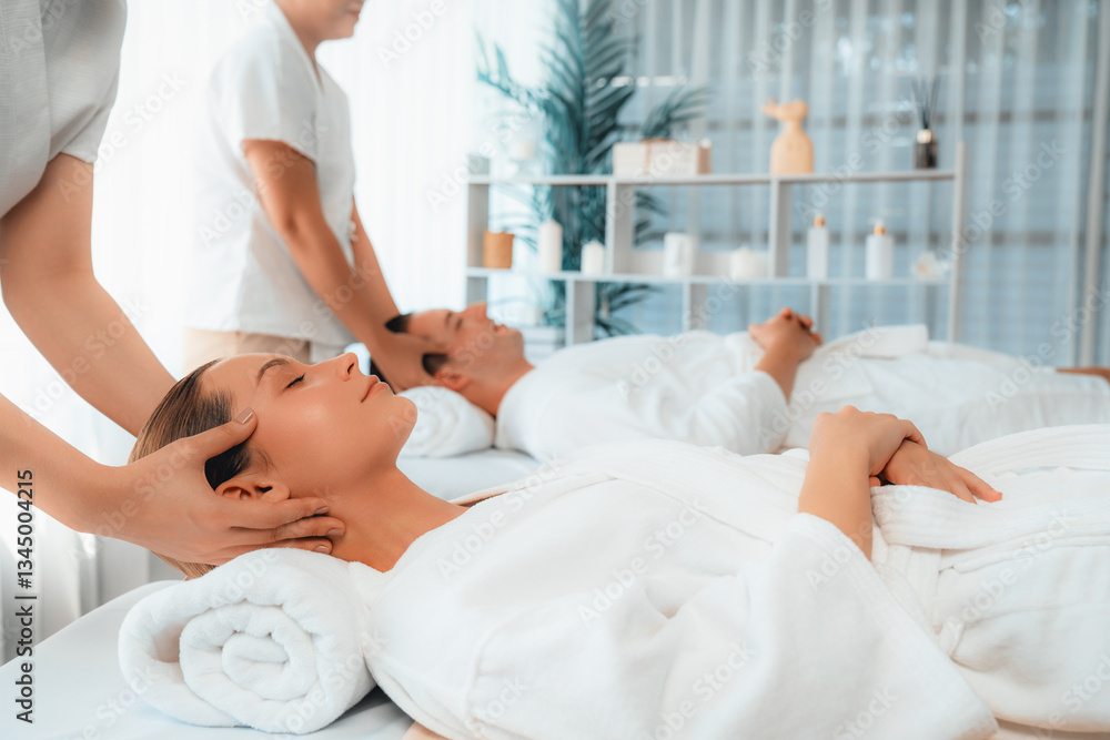 Fototapeta premium Caucasian couple enjoying relaxing anti-stress head massage and pampering facial beauty skin recreation leisure in dayspa modern light ambient at luxury resort or hotel spa salon. Quiescent