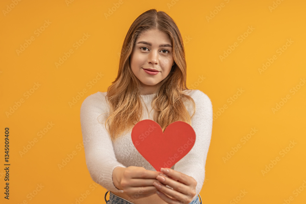 Woman presenting red heart-shaped card Woman presenting red heart-shaped card