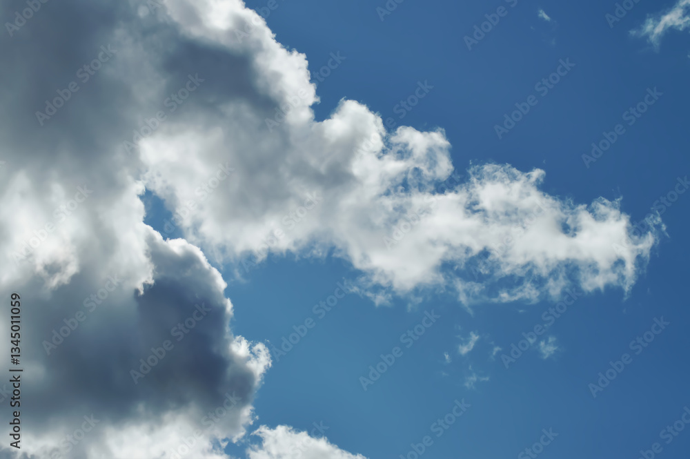 Fototapeta premium Large White Clouds in Daylight Blue Sky – Airy Nature Photography for Tranquil Designs, Editorial Projects, or Background Textures