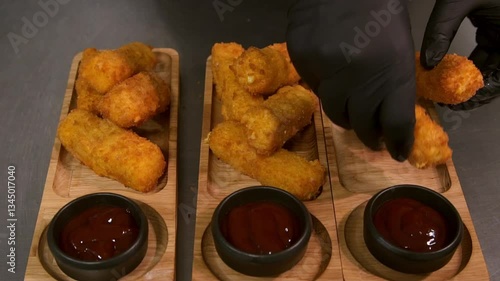 The chef lays out cheese sticks. Slow motion.