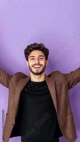 Young man in a brown blazer joyfully celebrating against a vibrant purple background