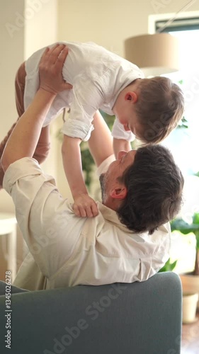 6 year old boy hugs dad and plays with him