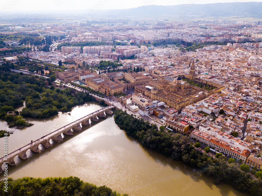 Fototapeta premium Aerial view of cityscape of Cordoba with Roman Bridge over the Guadalquivir and the Mosque-Cathedral of Cordoba