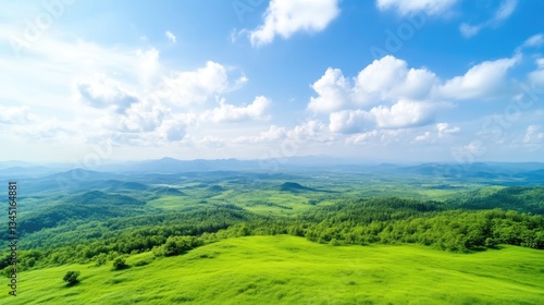 Vast green landscape, mountains, and sky