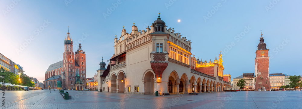 Evening view of the Main Square in Krakow, Poland, featuring the Cloth Hall and St. Mary's Basilica