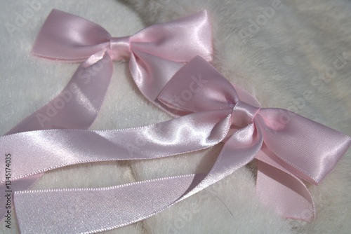 pink hair bows sitting on white fur