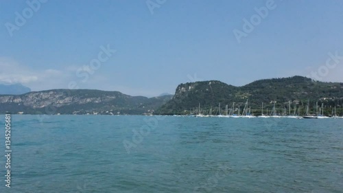 Panoramic view in Bardolino at the Garda Lake and ferris wheel in a typical Italian village from the pear