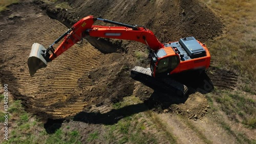  Excavator with big shovel in the excavation of the construction site. One machine works at a quarry, moving dirt. Heavy machinery at industrial construction site. Excavator digging soil pits 