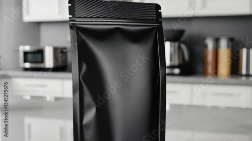 500g matte black coffee pouch standing upright on a clean white kitchen counter with blurred brewing tools.