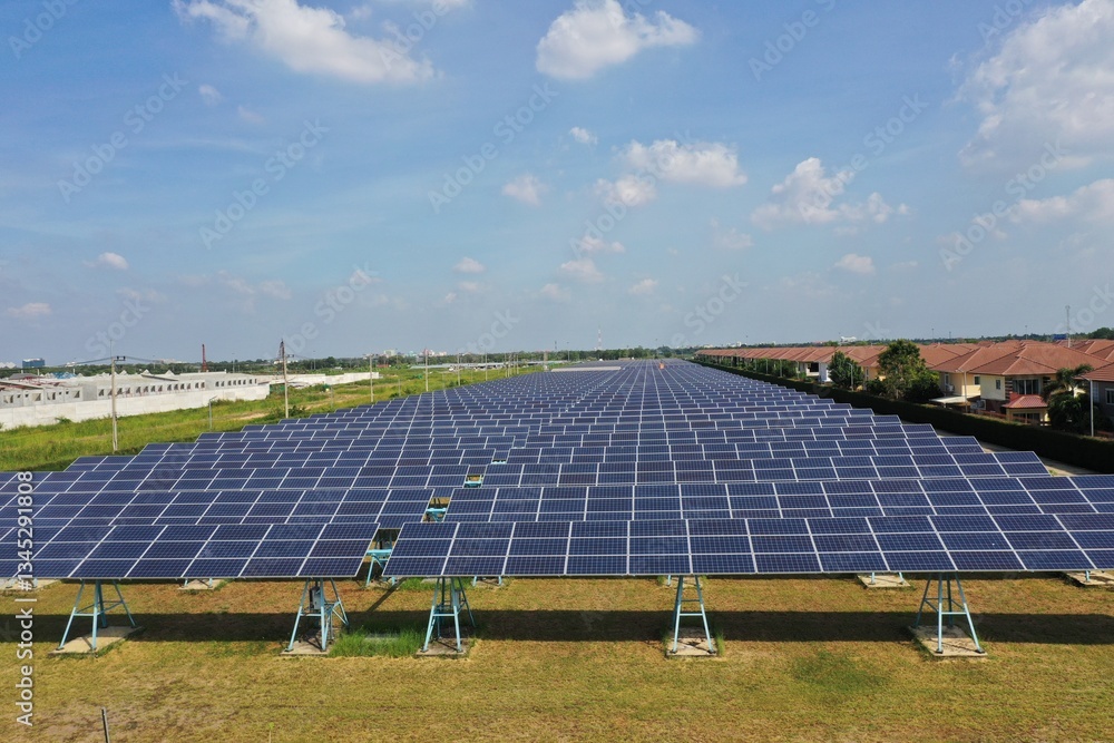 Solar Farm (solar cell) on sunny day background with electric power generation in agricultural area . Renewable green alternative energy. Power plant.Solar photovoltaic rows array ground mount system Solar Farm (solar cell) on sunny day background with electric power generation in agricultural area . Renewable green alternative energy. Power plant.Solar photovoltaic rows array ground mount system