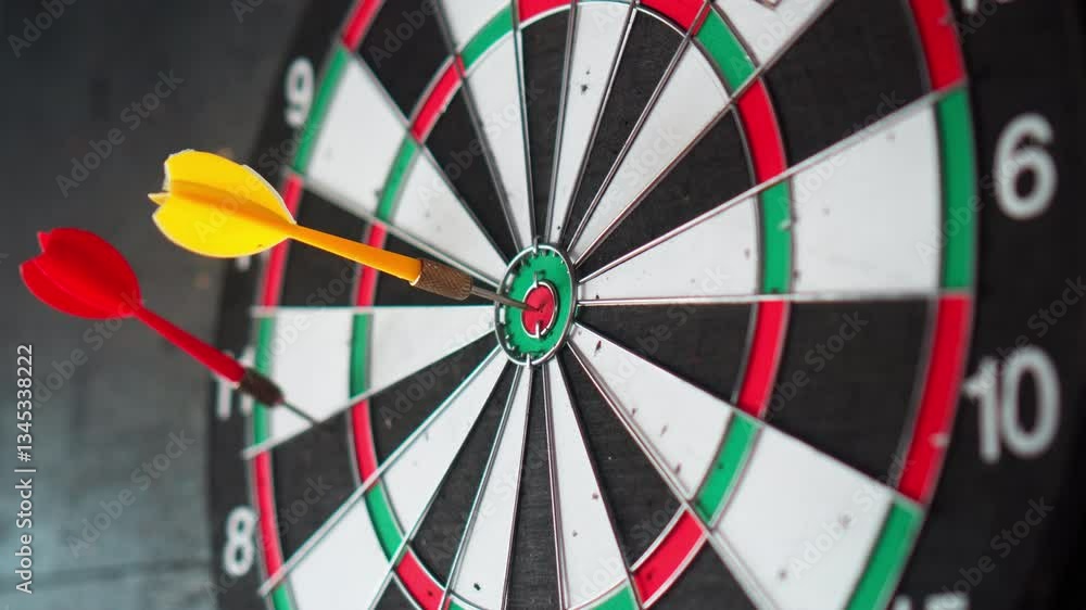 A dart board hangs on a black wall with darts stuck into it A dart board hangs on a black wall with darts stuck into it