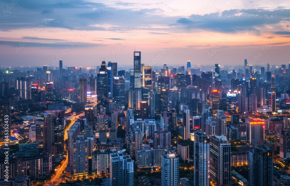 Fototapeta premium Aerial view of a vibrant city skyline at dusk.