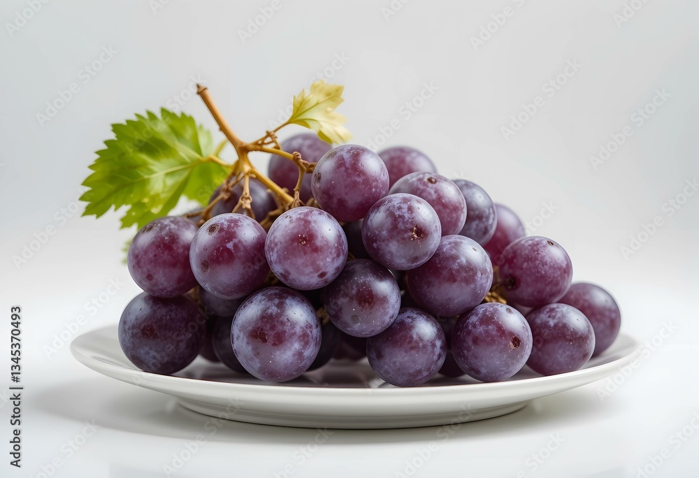 Fototapeta premium A bowl of fresh red grapes with a juicy bunch on a white background