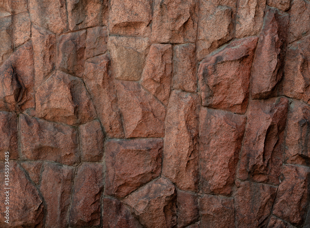 Fototapeta premium Stunning Close-Up of Textured Granite Wall Surface with Natural Brown Tones
