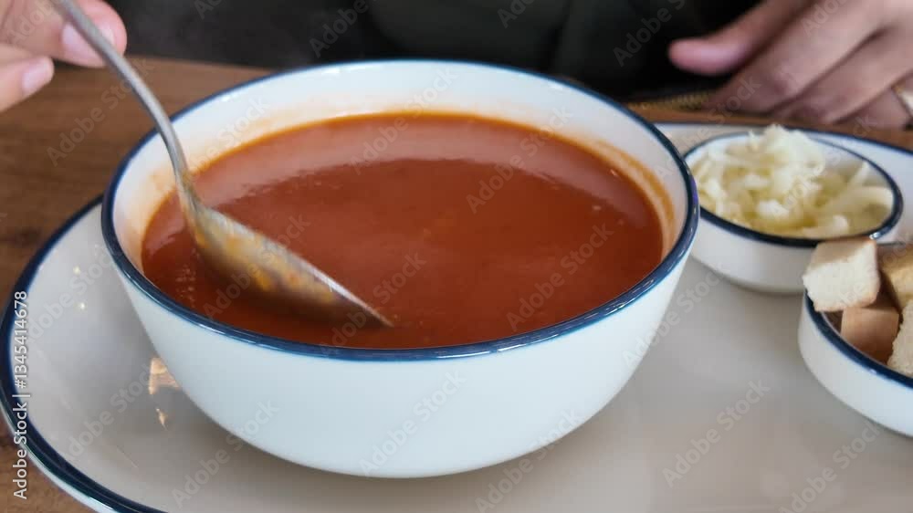 Delicious soup served in a bowl with side accompaniments Delicious soup served in a bowl with side accompaniments