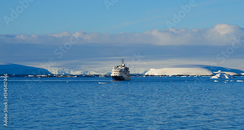 Cruise Ship entering Lemaire Channel off the coast of Antarctica, separating Kyiv Peninsula on the mainland and Booth Island