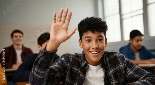 Hispanic teen male student raising hand in classroom with classmates