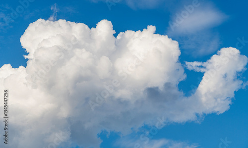 Clouds at the sky. Cloudscape - Blue sky and white clouds. Beautiful blue sky background with clouds. White fluffy clouds in the blue sky. Blue sky and white clouds of daytime