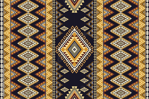 Abstract ethnic geometric texture pattern. Seamless brown and yellow color of tribal abstract fabric textile on dark violet and back background