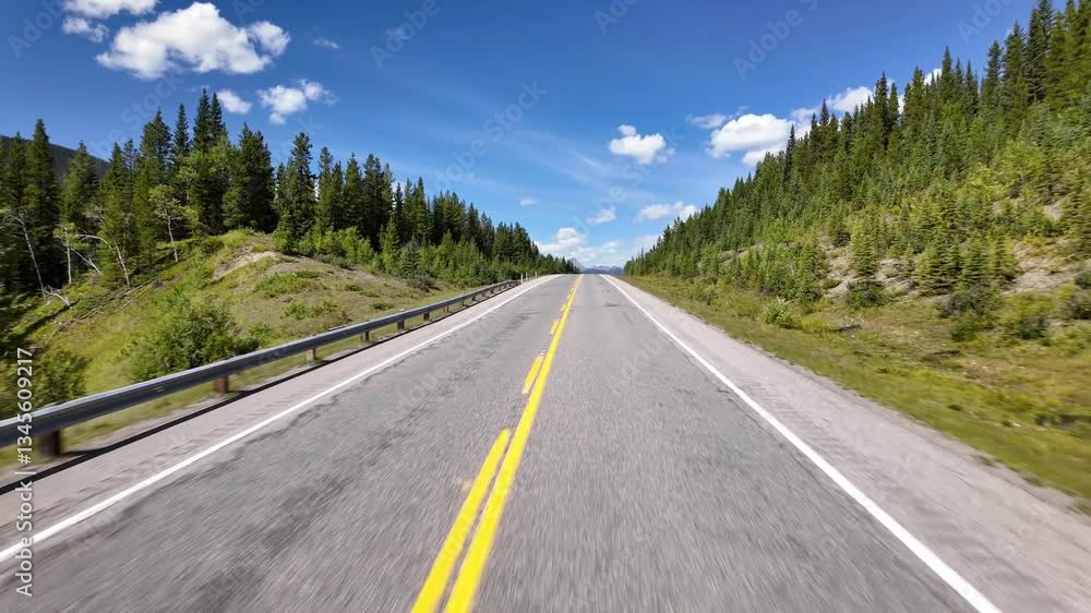 Driving on Scenic Highway Through Mountains and trees. Blue sky. BC, Canada. Driving on Scenic Highway Through Mountains and trees. Blue sky. BC, Canada.