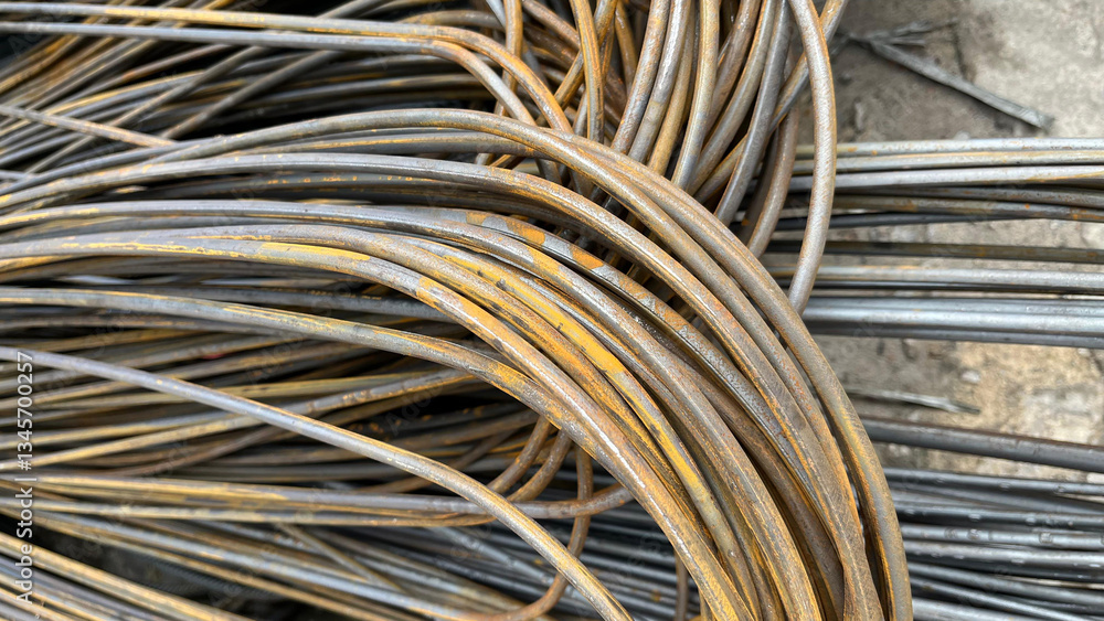 Closeup of steel rods or bars used to reinforce concrete on ground. Rolled metal warehouse. Steel rods and wire for the construction of reinforced concrete structures Closeup of steel rods or bars used to reinforce concrete on ground. Rolled metal warehouse. Steel rods and wire for the construction of reinforced concrete structures